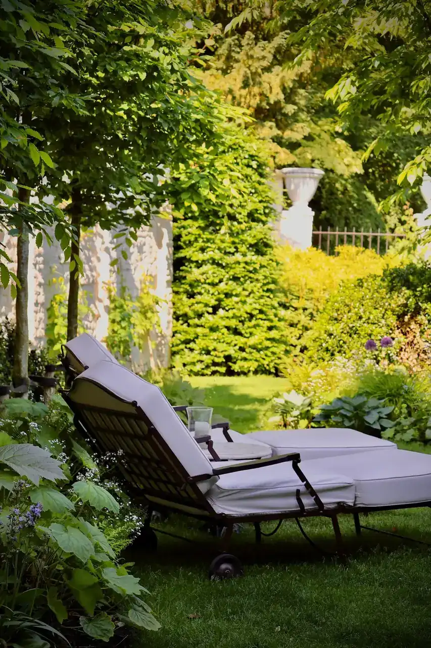 A cushioned lounger in a sunlit hotel garden