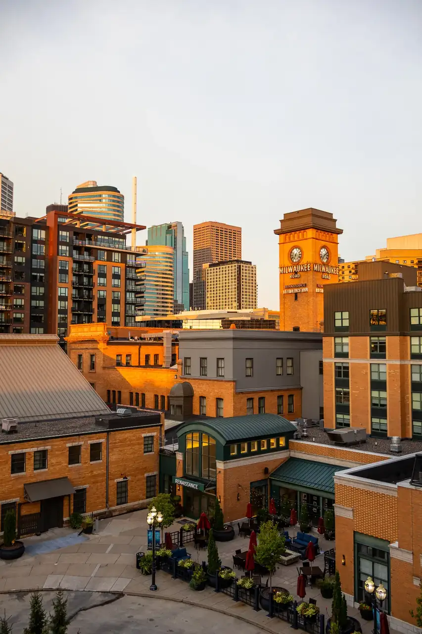 Brick hotel buildings and city towers glowing at golden hour